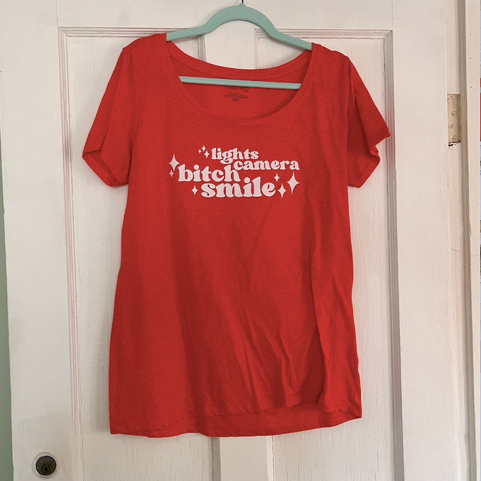 "lights camera bitch smile" warm orange swiftie t-shirt (ladies medium)
