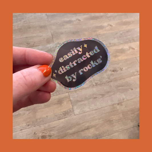 easily distracted by rocks sticker (glitter)